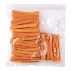 a package of orange cotton swabs on top of a plastic bag next to a white button