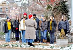 a group of people standing outside in the snow