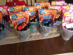 several buckets filled with candy sitting on top of a table