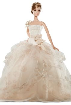 a barbie doll wearing a wedding dress with ruffles and flowers on the skirt