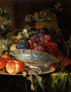 a painting of fruit on a table next to a vase with grapes and other fruits in it