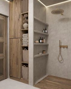 a bathroom with shelves, shower head and toiletries on the shelf next to it