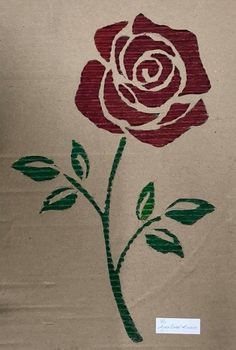 a brown paper bag with a red rose painted on it