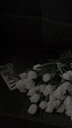 a bunch of white flowers sitting on top of a couch