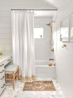 a white bathroom with a shower, sink and bathtub