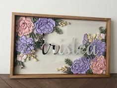 a wooden frame with flowers on it that says,'sister'in cursive writing