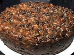 a chocolate cake sitting on top of a white plate