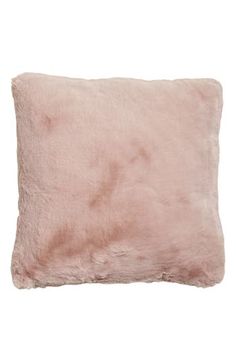 a pink pillow on a white background