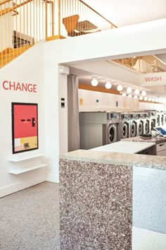 the wash room is clean and ready to be used for washing machines in this store