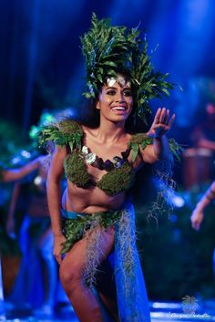 a woman in a hula skirt on stage