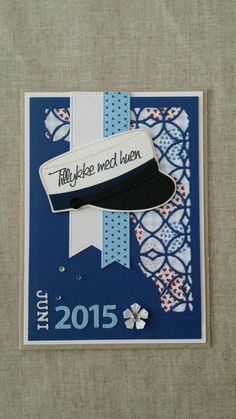 a blue and white card with a ribbon on it