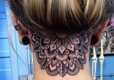 a woman's neck tattoo with an intricate design