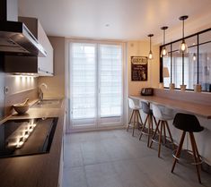 the kitchen is clean and ready to be used for cooking or eating, as well as bar stools