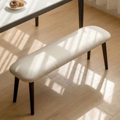 a white bench sitting in front of a table with donuts on top of it