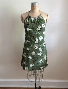 "Olive green floral/daisy print halter mini-dress from the 1990s. Bust measures 17.5\" (44.5 cm) flat across and waist measures 16\" (40 cm) flat across. The dress is 34\" (86.5 cm) long, not including tie. Polyester." Yellow Plaid Shirt, Plaid Dress Shirt, Yellow Plaid, Brown Silk, Beautiful Sweater, Halter Mini Dress, Daisy Print, 1950s Dress, Gorgeous Dresses