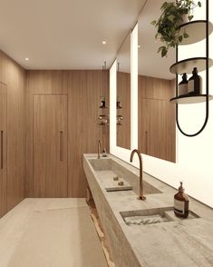 a bathroom with double sinks and wooden cabinets