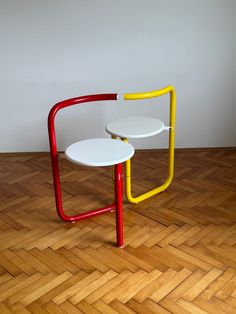 two tables sitting side by side on top of a wooden floor