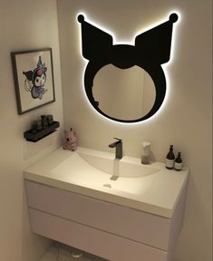 a bathroom with a sink, mirror and lights on the wall above it is decorated in black and white