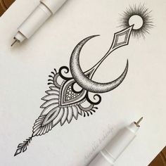 an ink drawing of a crescent moon with feathers and sun on the side, next to a fountain pen