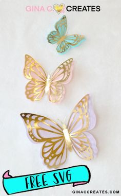 three gold and blue butterflies with the text free svg on it in front of them