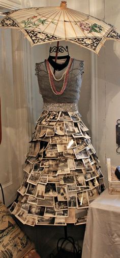 a dress made out of newspapers and an umbrella