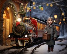 a little boy standing next to a train on the tracks in front of christmas lights