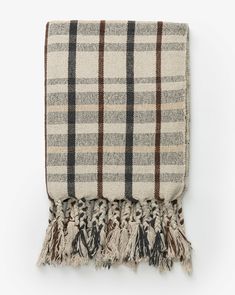 a plaid blanket with tassels on it