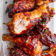 chicken wings covered in bbq sauce and garnished with parsley on top