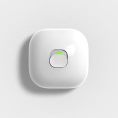 a white button with a green light on it