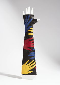 a black glove with multicolored hands on it