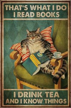 a cat sitting in a chair with a book on it's lap and drinking tea