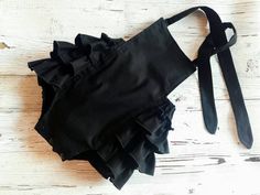 "Do you love minimalism like solid colors instead of bold prints?  Then you will love the look of this deep black solid baby romper!  Your little princess will look very dressy and cute in this little ruffled bottom romper.  It has 3 large and full ruffles on the back that wrap around to the front for that vintage look!  Front is fully lined.  100% cotton fabric is machine washable in cold, tumble dry low.  I hope you love this little romper as much as I enjoy making it! Available in Newborn - 18-24 Months sizes Made with crotch snaps. Size chart is as follows:            Size.           Approx. length, from top of bodice to crotch            NB.                     10\"            0-3 M.                 11.5\"            3-6 M.                 12\"            6-12 M.               14\" Baby Bubble Romper, Goth Baby, Baby Bubble, Baby Clothes Patterns, Bubble Romper, Fashion Website, Deep Black