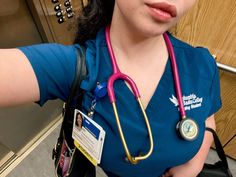 a woman with a stethoscope on her neck is posing for the camera