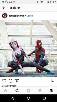 two spider - man are sitting on the ground