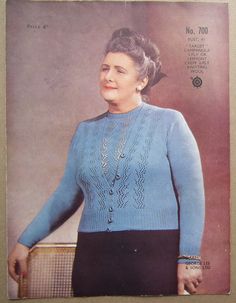 an older woman wearing a blue sweater and black pants with her hair in a bun