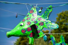 a green giraffe shaped kite hanging from a line