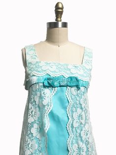 "This 1960's dress reminds me of a dress version of Marvelous Mrs. Maisel nightgown. It has a bright blue A-line shape dress with a overlay of lace that is not attached to the dress so when you walk it really moves with you. It has the original metal zipper up the back with a beautiful tule netting petite coat underneath. I tacked down the bow so it will no long flap as it shows in the picture. This dress would look great with white shoes and a high neck rhinestone necklace! Measurements: Fits l Sleeveless Blue Coquette Dress, Flirty Sleeveless Blue Dress, Blue Lace Trim Coquette Dress, Coquette Sleeveless Nightgown For Party, Vintage Fitted Nightgown For Party, Summer Party Coquette Nightgown, Coquette Summer Party Nightgown, Vintage Blue Wedding Nightgown, Blue Vintage Wedding Nightgown