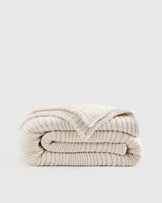 two white blankets stacked on top of each other