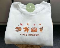 Cozy Season Fall Leaves Embroidered Sweatshirt, Spooky Fall Hoodie, Coquette Pumpkin Spice Shirt, Fall Sweatshirts For Women, Thanksgiving This sweatshirt is crafted from high-quality cotton weave and features advanced embroidery technology to ensure vibrant colors and intricate patterns. It's unisex, soft, and comfortable, making it perfect for a stylish, casual look. Each sweatshirt boasts a unique aesthetic, making it a timeless gift for family, friends, or teachers. Size: We offer a range of Fall Outfits Sweatshirts, Cricut Sweaters, Women Sweatshirt Outfit, Fall Sweatshirt Ideas, Coquette Pumpkin, Embroidering Machine, Advanced Embroidery, Pumpkin Spice Shirt, Spooky Fall