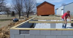 a man is building a house out of cinder blocks