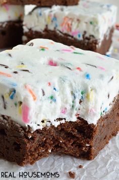 there is a piece of cake with white frosting and sprinkles on it