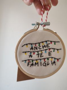 someone is holding up a hand embroidered ornament that says, meme ate famigin