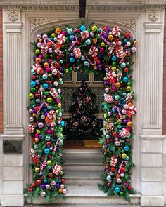 an arch decorated with christmas decorations and candy canes