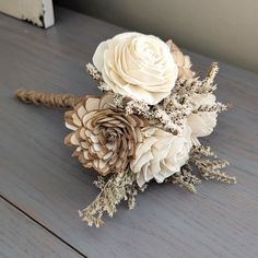 a bridal bouquet with white flowers on a wooden table