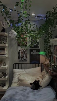 a bedroom with plants hanging from the ceiling, and a bed in front of it