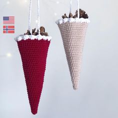 two crocheted cones hanging from strings with pine cones on them, one is red and the other is white