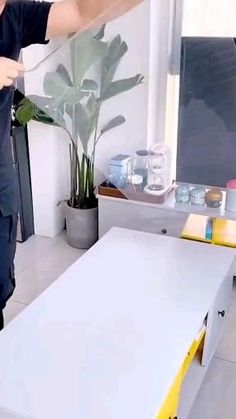 a man standing in front of a white table with a banana on top of it