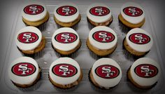 twelve cupcakes with frosting and the san francisco logo on them