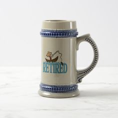 a beer mug with the words retired on it and a man in a boat behind it