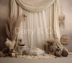 an image of a backdrop with feathers and lanterns on the floor in front of it